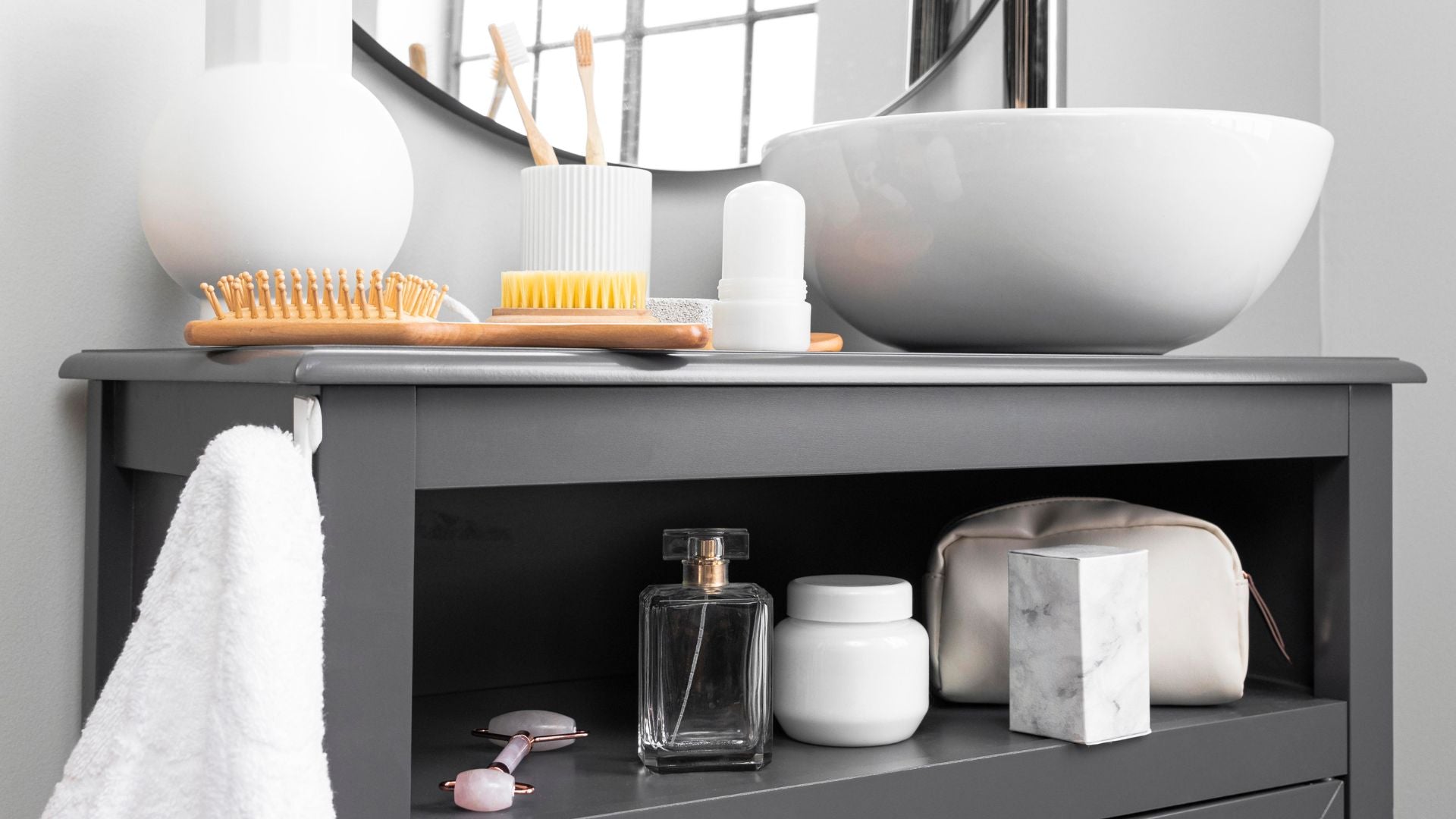 Modern bathroom counter with sink and neatly arranged toiletries — The Neat Nest essentials for organized living.