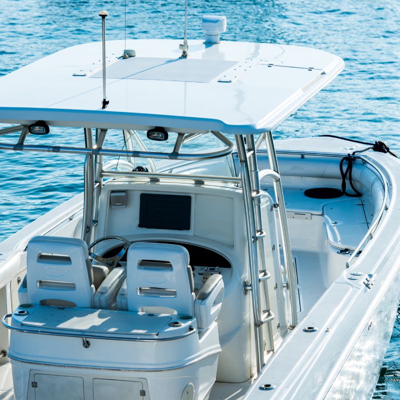 White boat on clear blue water — The Neat Nest essentials for boating and marine storage.